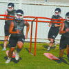 ON THE MOVE: Marlow linemen go through a chute drill on the first day of practice Monday afternoon.