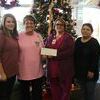 Presenting the check were Faith McManis, a second-year Cosmetology student from Walters (far left), and Naomi Burden, an adult BITE student who also serves as the BPA President (far right). Receiving the check on behalf of the Cancer Center were Janada Jenkins, RN (second from left) and Sharon Mitchell, Lab Assistant (second from right).