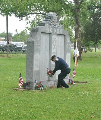 Veteran Larry Davidson places a wreath during the 2020 Memorial Day ceremony at Memorial Park in Duncan.