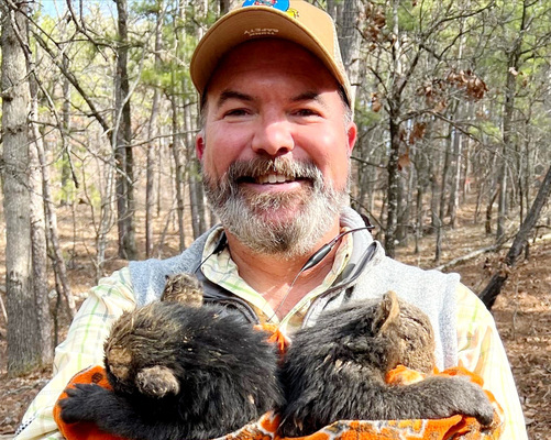 Oklahoma Wildlife Department Director JD Strong with a pair of black bear cubs. Photo issued with story about Strong's sudden resignation from his position.