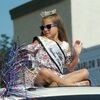 QUEEN CAB: Stephens County Free Fair Little Miss queen Addilen Wright sits atop a truck and waves to the crowd as part of the Marlow Fourth of July parade Tuesday.