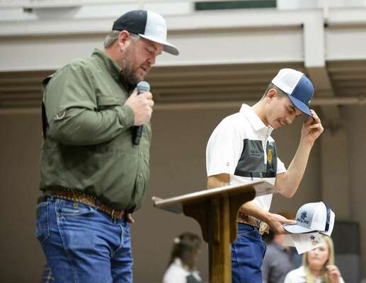 Auctioneer Kenny Baker shows some personal emotion as his son, Korben Baker, steps onto the auction stage, Thursday, Dec. 1, 2022, for the annual MHS FFA Labor Auction fundraiser. Photo by Toni Hopper/The Marlow Review