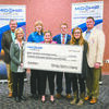 CHECK PRESENTATION: School and local officials celebrate receiving a $20,000 check from Midship Pipeline. Pictured: (front row, from left) Sylvia Loveday, Program Director; Laure Ferrell, Midship Pipeline Company; Kaitlyn Snider, Pre-engineering instructor; (back row) Sam Porter, School Board Member; Gretchen Taylor, Pre-engineering instructor; State Rep. Brad Boles; and Brook Holding, Deputy Superintendent, Red River Technology Center