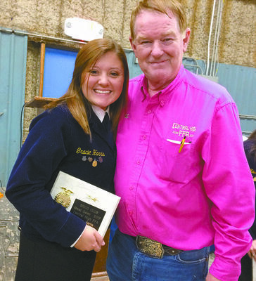 TOP EARNER: Central High FFA's Gracie Harris 2017 High Meat salesperson receiving her award from FFA advisor RJ Curry at last year’s Central High FFA Labor Auction