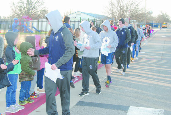 SENDOFF: Marlow Elementary School students wished the high school wrestling team good luck before they boarded the buses to head to Dual State last Friday. The team would go on to finish as state runner-up. The Outlaws are hosting the Class 3A West Regional this Friday and Saturday.
