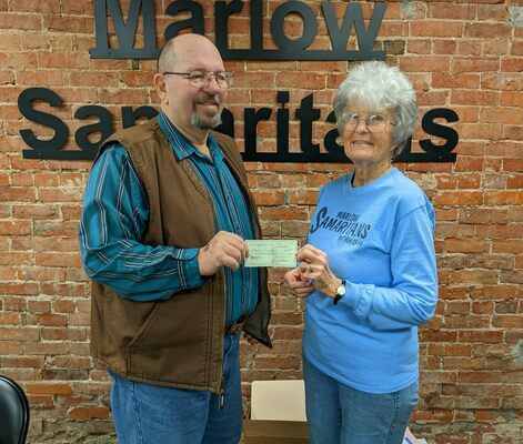 Rev. Lynn Parkhurst presents Sandy Chatfield, secretary for the Marlow Samaritans, a check for $575 from the Marlow Ministerial Alliance. Donations were taken during the Community Wide worship service held Nov. 20, 2022.