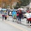 GETTING WET: Staff and volunteers from the Garland Smith Public Library walk along the Marlow parade route on Saturday morning. The weather conditions made attendance and participation smaller, but most people still seemed to enjoy themselves.