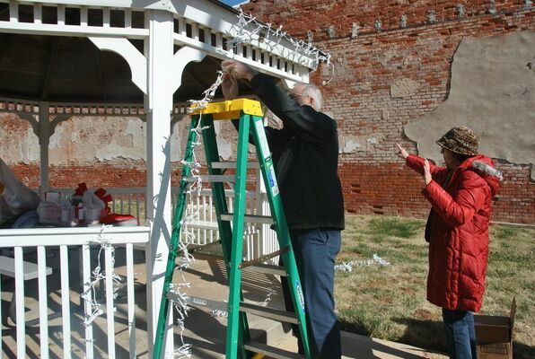 Chamber Board members decorate the gazebo in the park on Main Street for the holidays