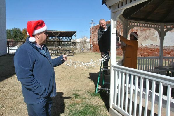 Chamber Board members decorate the gazebo in the park on Main Street for the holidays
