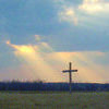 RESURRECTION SUNDAY: A cross stands alone in a field as sunbeams surround it. This Sunday marks the most holy day on the Christian calendar as believers celebrate the resurrection of Jesus Christ.