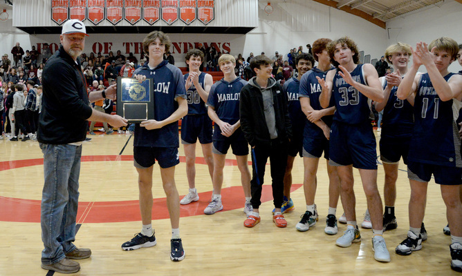 Outlaw player Canton Clark accepts the Stephens County Tournament Champion plaque on behalf of the team. 
Photo by Toni Hopper/The Marlow Review