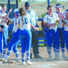 HOME RUN: Central High’s Katelynn Vandever is greeted at home by teammates after hitting a home run against Geronimo at the district tournament last Thursday.