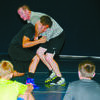 Former Marlow Outlaw wrestling great Mike Lightner, now assistant wrestling coach at the University of Oklahoma (right) shows a wrestling move to campers