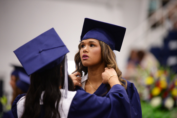 Maya Cantwell adjusts the collar on Karlee Harrison’s gown before the Marlow High School graduation ceremony. Photo by Toni Hopper/The Marlow Review