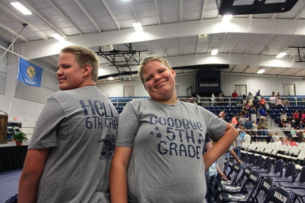 Twin brothers Zachary and Nicolas Ausmus show off their matching T-shirts on 5th grade promotion day, Thursday, May 18, 2023, at the Outlaw Gymnasium. 
Photo by Toni Hopper/The Marlow Review