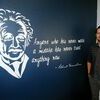 READY TO GET STARTED: New Marlow science teacher Taylor Schooling stands with a mural of Albert Einstein he and his wife painted for his high school classroom. It is one of two murals in the classroom.