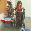 THINKING OF OTHERS: Kara Poplin stands with the walker she purchased for her Uncle Ronnie Shipman at the Santa Shop, a PTO fundraiser, after telling her aunt she wanted to spend her money on him, not herself.